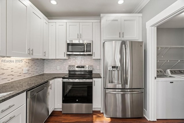 kitchen with white cabinetry, stainless steel appliances, and washing machine and dryer