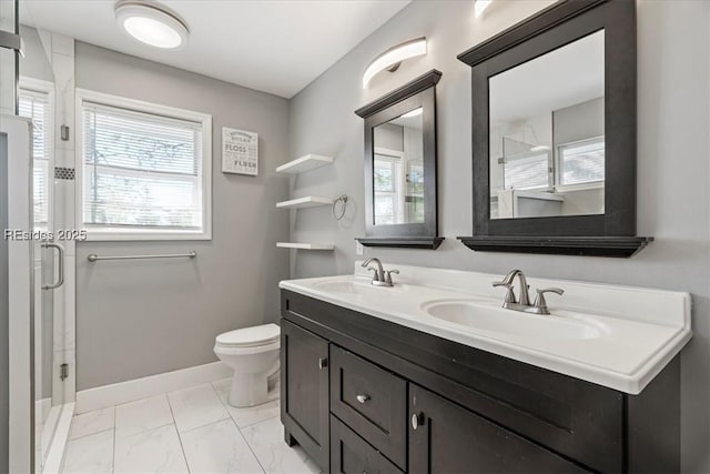 bathroom featuring a shower with door, vanity, plenty of natural light, and toilet