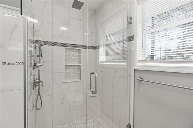 bathroom featuring a shower with door