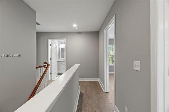 hall with hardwood / wood-style floors