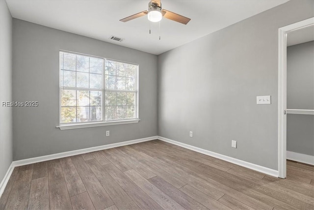 unfurnished room with ceiling fan and light wood-type flooring