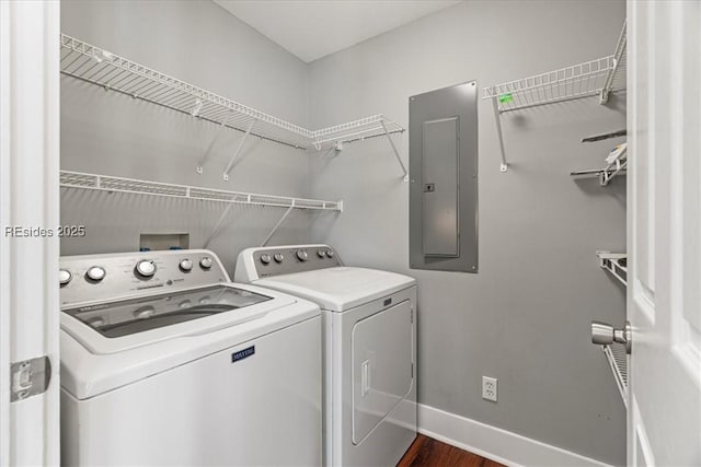 laundry room with separate washer and dryer, dark hardwood / wood-style flooring, and electric panel