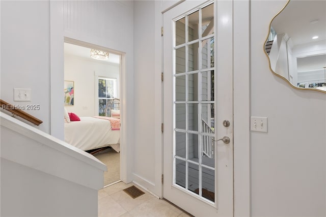 doorway featuring light tile patterned flooring