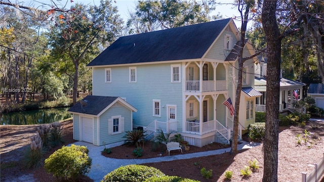 view of front of property featuring a balcony and a garage