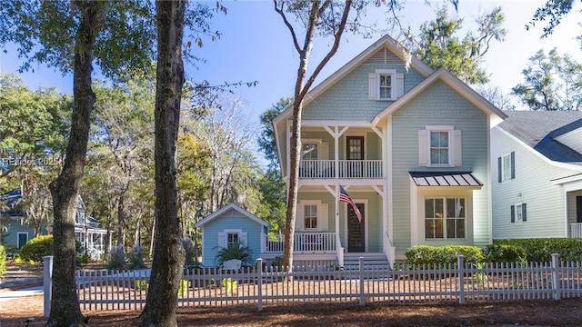 view of front of property featuring a balcony and a porch