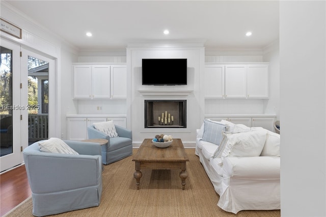 living room with crown molding, light hardwood / wood-style flooring, and french doors