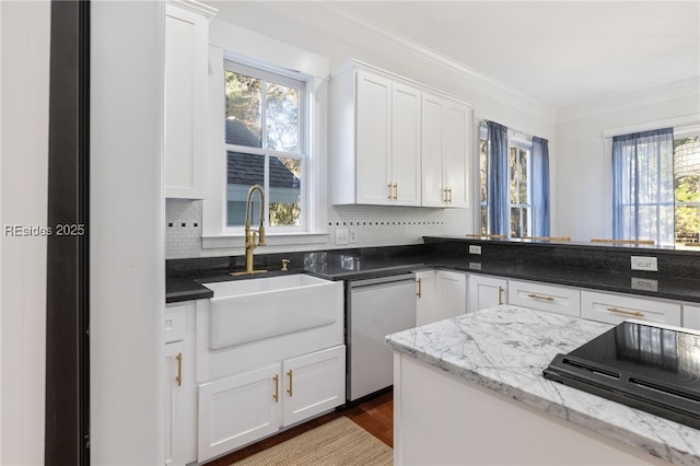 kitchen with dishwasher, sink, and white cabinets