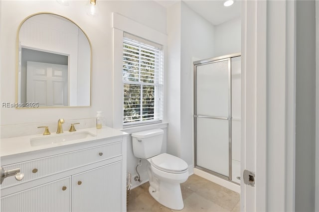 bathroom with vanity, toilet, tile patterned flooring, and a shower with door