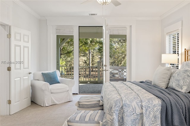 carpeted bedroom with ceiling fan, ornamental molding, and access to exterior