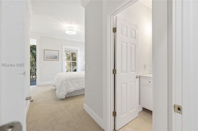 hall featuring crown molding and light colored carpet