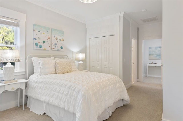 bedroom with light carpet, crown molding, and a closet