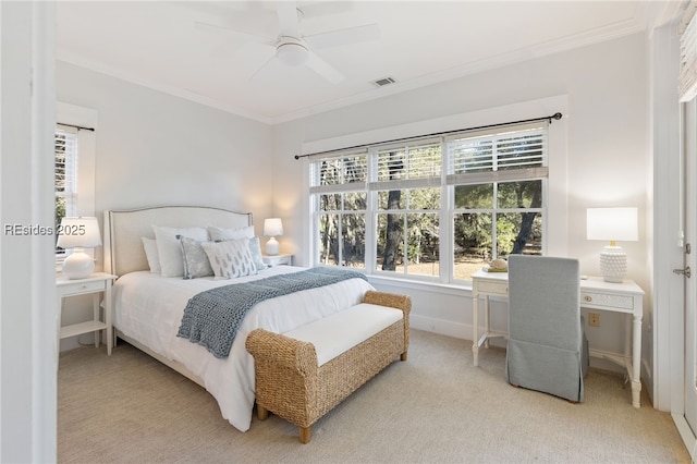 bedroom featuring ceiling fan, ornamental molding, and light carpet