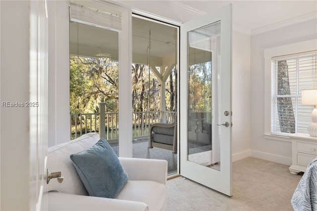 entryway featuring crown molding and light colored carpet