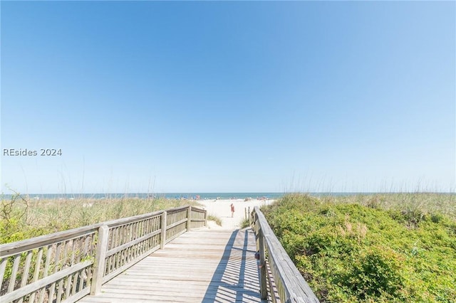 surrounding community with a view of the beach and a water view