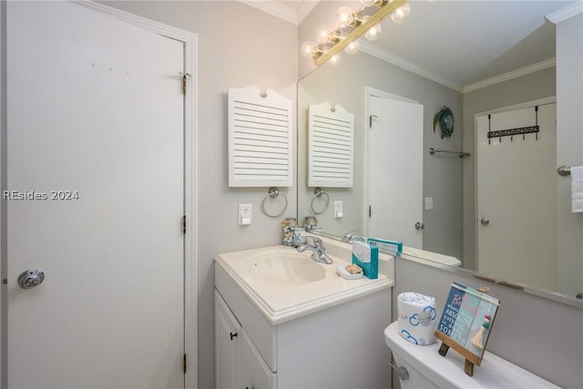 bathroom with crown molding, vanity, and toilet