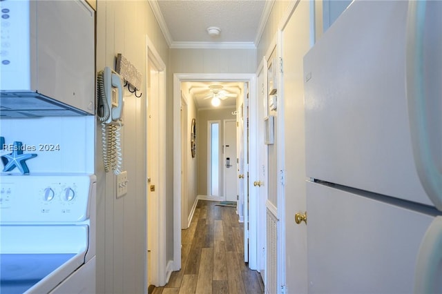 hall featuring washer / clothes dryer, dark wood-type flooring, ornamental molding, and a textured ceiling