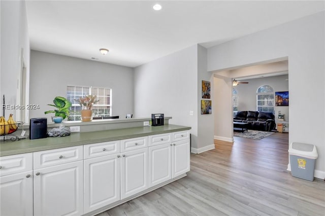 kitchen featuring white cabinetry, light hardwood / wood-style flooring, and ceiling fan