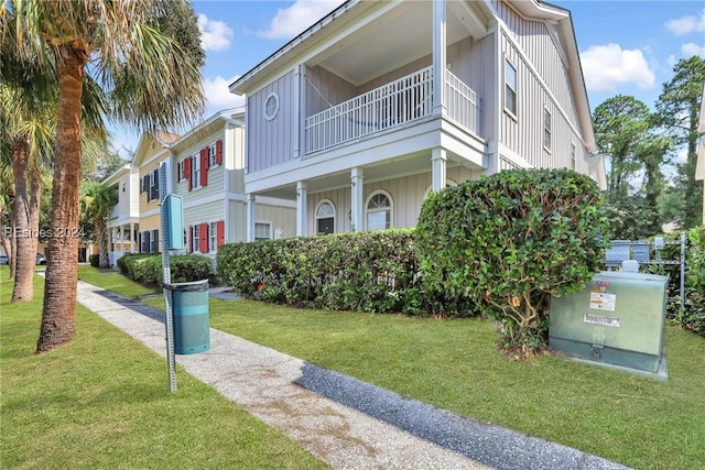 exterior space with a front lawn and a balcony