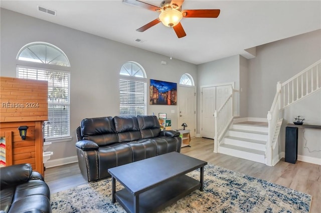 living room featuring ceiling fan and light hardwood / wood-style floors