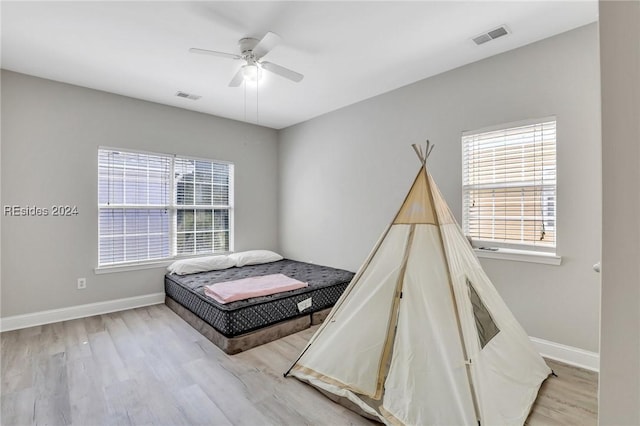 bedroom featuring ceiling fan and light hardwood / wood-style floors