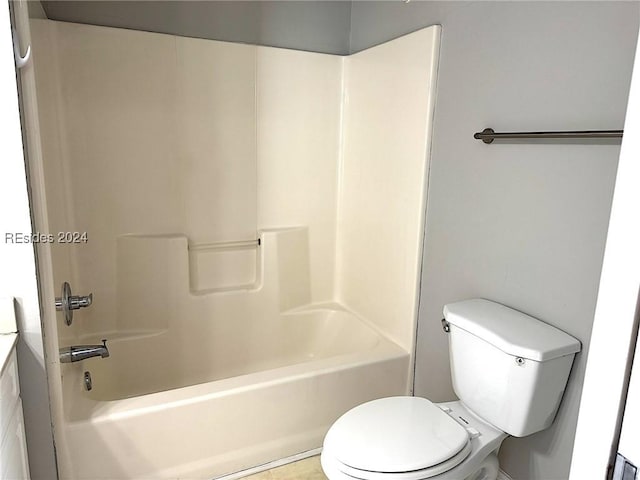 bathroom featuring tile patterned floors, toilet, and washtub / shower combination