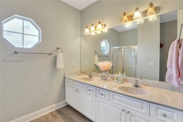 bathroom with vanity, hardwood / wood-style floors, and an enclosed shower