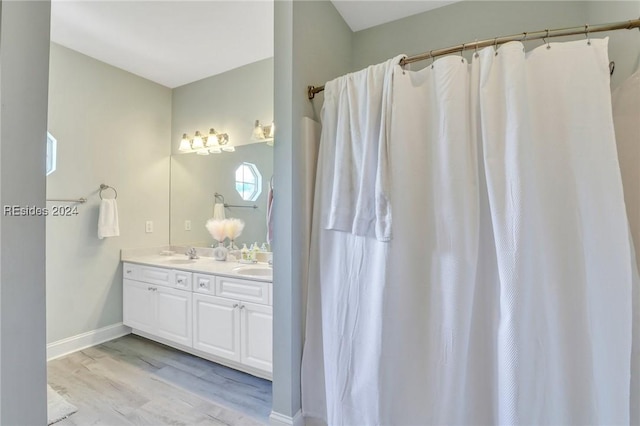 bathroom featuring hardwood / wood-style flooring and vanity