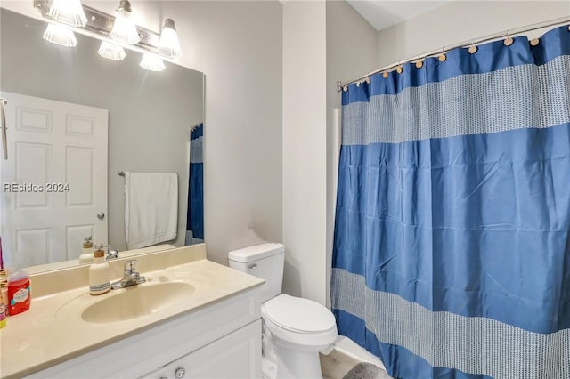 bathroom with vanity, toilet, and a shower with shower curtain