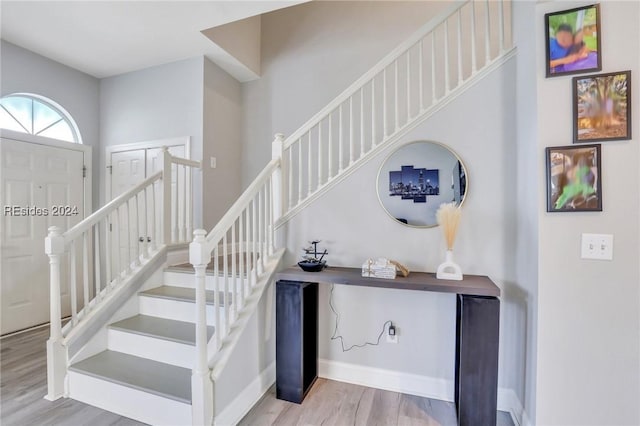 staircase with hardwood / wood-style flooring