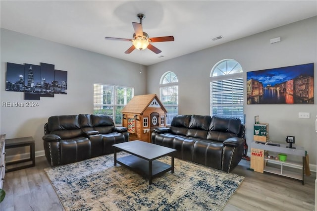 living room featuring hardwood / wood-style flooring and ceiling fan