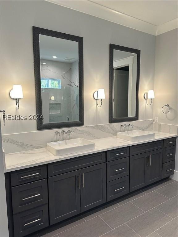 bathroom with vanity, tile patterned floors, a shower with shower door, and ornamental molding