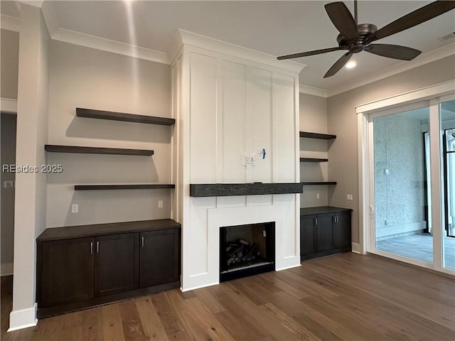 unfurnished living room with dark wood-type flooring, ornamental molding, and a healthy amount of sunlight