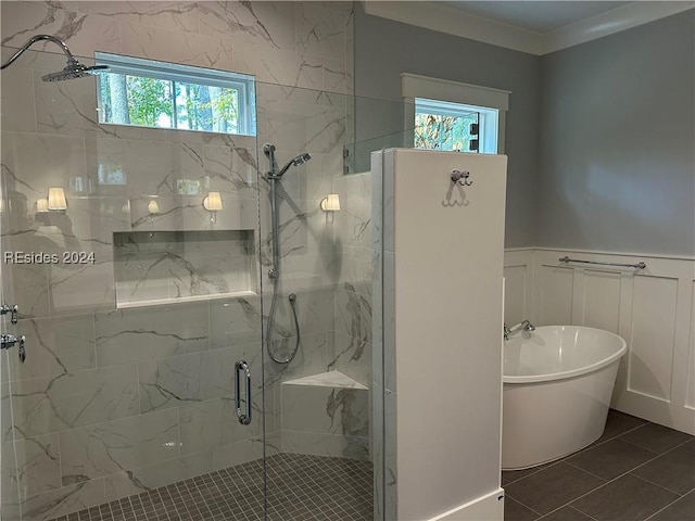 bathroom with tile patterned floors, plenty of natural light, plus walk in shower, and ornamental molding