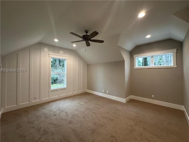 bonus room with vaulted ceiling, ceiling fan, and carpet