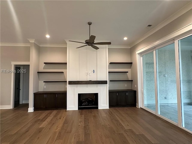 unfurnished living room with a wealth of natural light, dark wood-type flooring, and ornamental molding