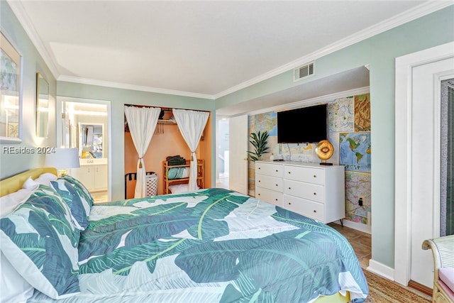 bedroom with connected bathroom and ornamental molding