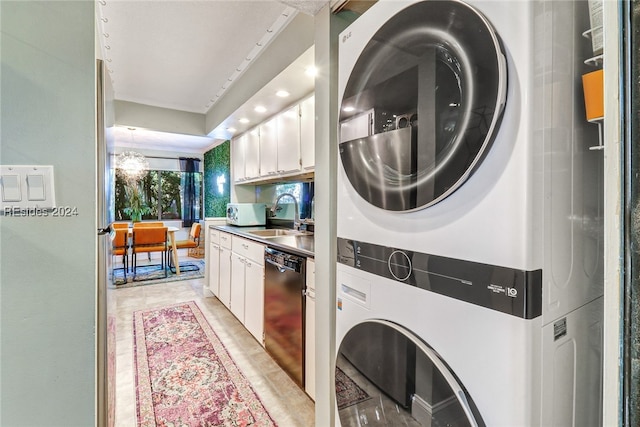 washroom with stacked washer and clothes dryer and sink