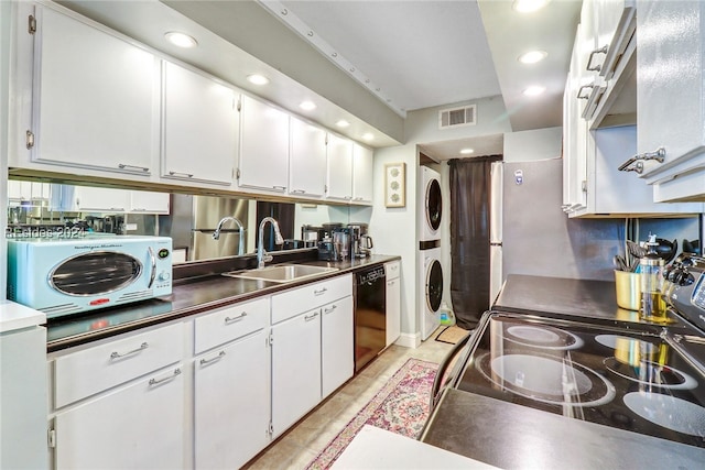 kitchen featuring sink, stainless steel electric range oven, dishwasher, stacked washing maching and dryer, and white cabinets