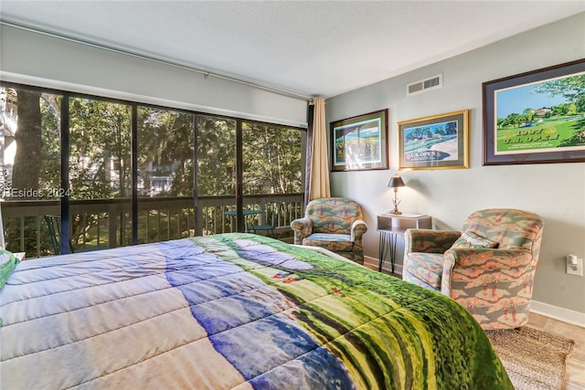 bedroom featuring tile patterned flooring and access to exterior