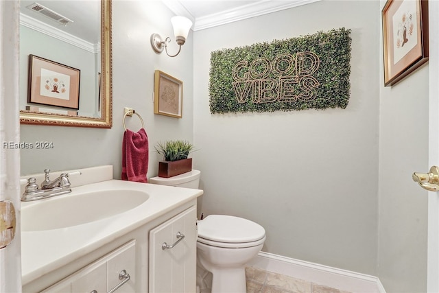 bathroom with tile patterned flooring, crown molding, vanity, and toilet