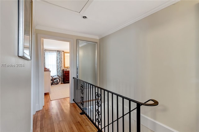 hall with crown molding and light hardwood / wood-style floors