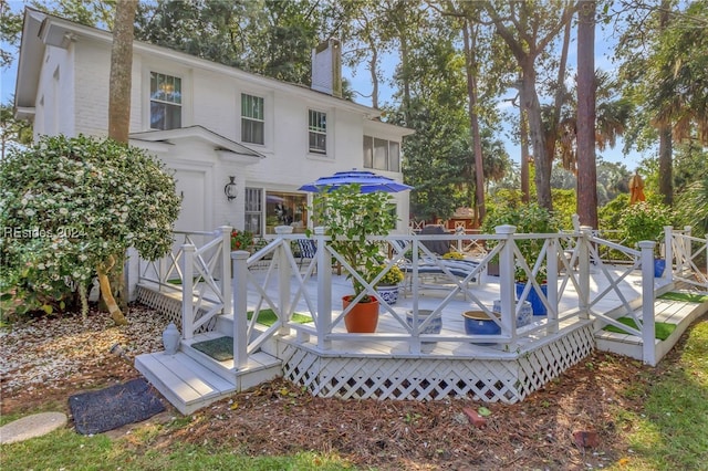 rear view of property featuring a deck