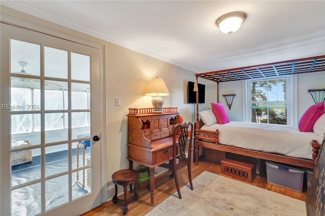 bedroom featuring hardwood / wood-style floors and ornamental molding