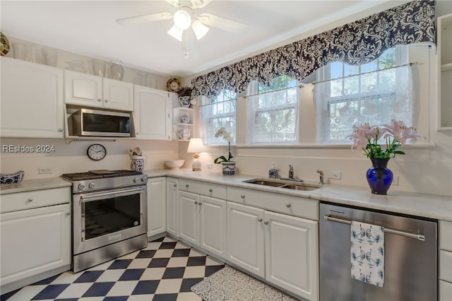 kitchen featuring white cabinetry, appliances with stainless steel finishes, sink, and a healthy amount of sunlight