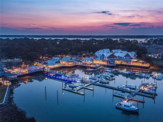 aerial view at dusk featuring a water view