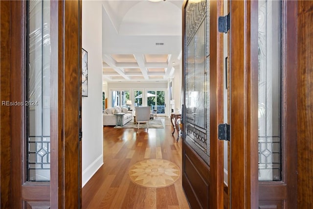 foyer with coffered ceiling, hardwood / wood-style floors, and beam ceiling