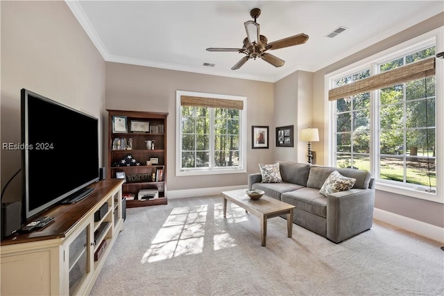 living room featuring ornamental molding, a healthy amount of sunlight, and light colored carpet