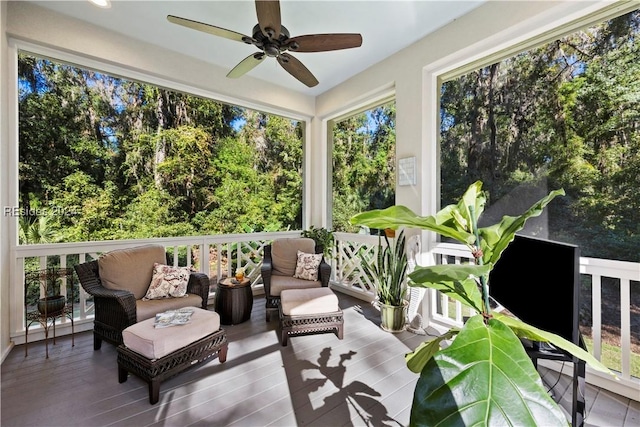 sunroom / solarium featuring ceiling fan