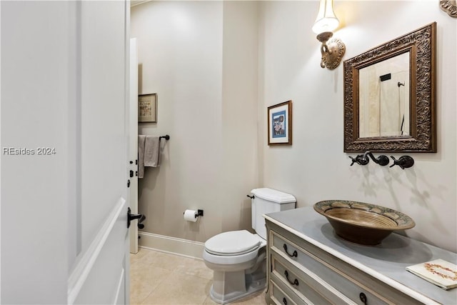 bathroom with vanity, tile patterned floors, and toilet