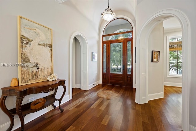 foyer with crown molding and dark hardwood / wood-style flooring